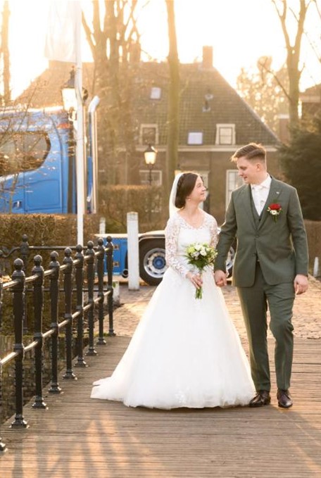 Bride and groom on a bridge.
