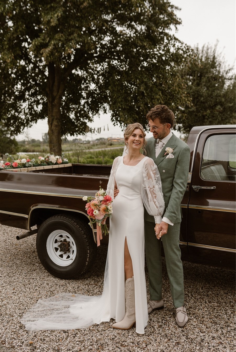 Bride and groom by vintage truck.
